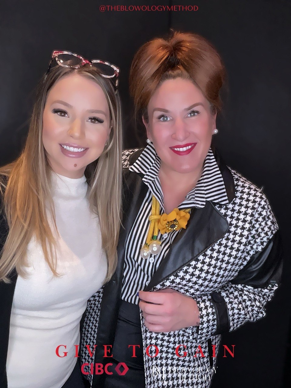 Two guests posing at a CIBC Give to Gain event photo booth